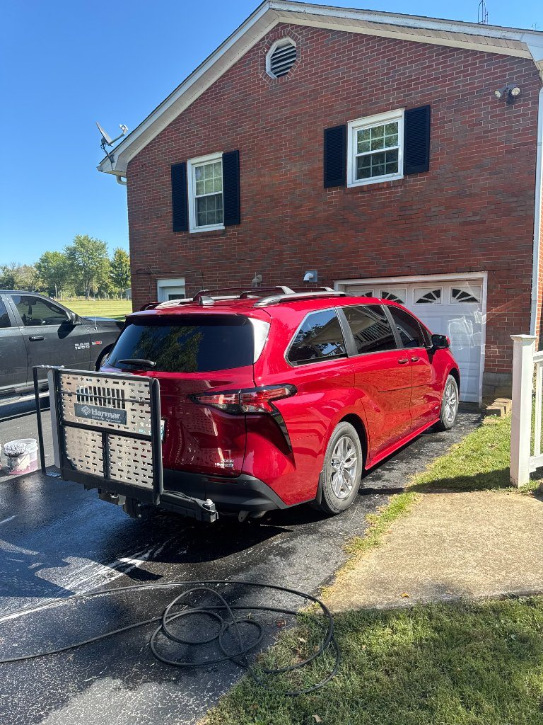 Freshly detailed red Toyota Sienna in a Kentucky driveway